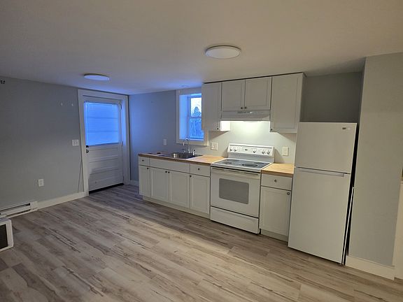 Large kitchen with butcher block countertop