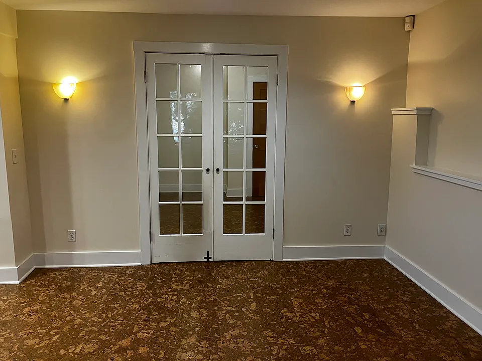 view of french doors to bedroom from living room