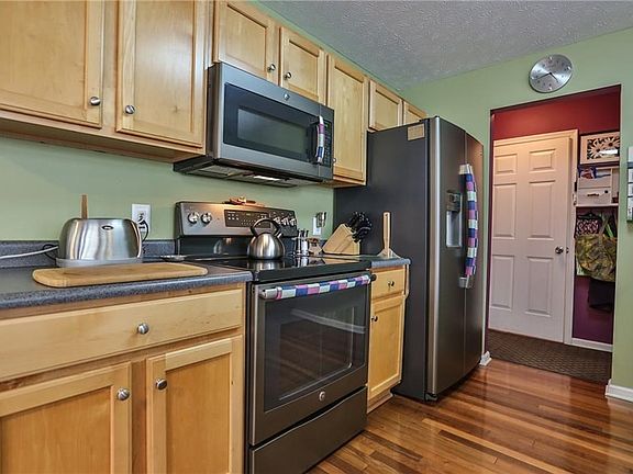 Kitchen Area (view looking back onto entry hallway).  Two car garage is conveniently located near kitchen.  So easy to carry groceries from your car to the pantry and refrigerator.