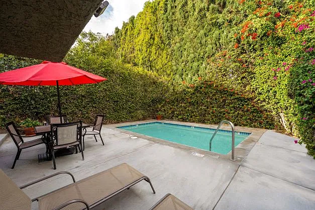 The pool at the Ridgeview apartment surrounded by beautifully manicured trees.