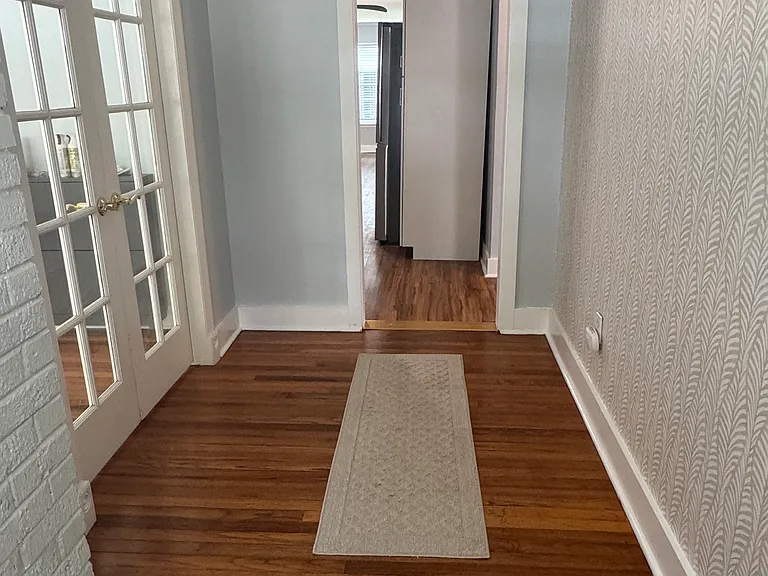 Front hallway leading into bedroom on left.