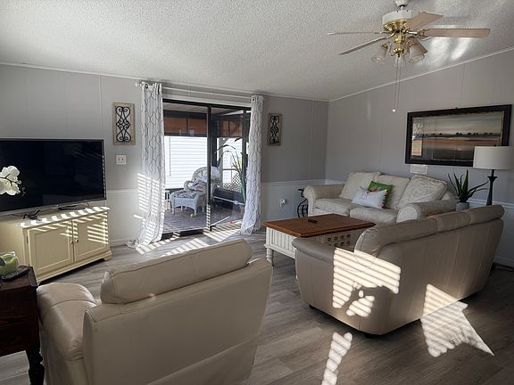 Living area with sliders to screened in porch