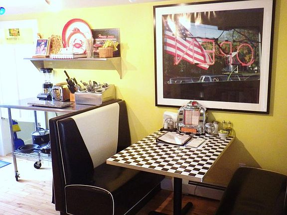 Retro theme KITCHEN with diner booths and a stainless steel work table.