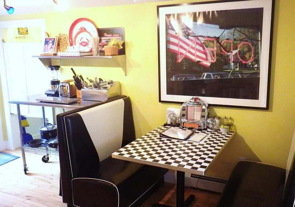 Retro theme KITCHEN with diner booths and a stainless steel work table.