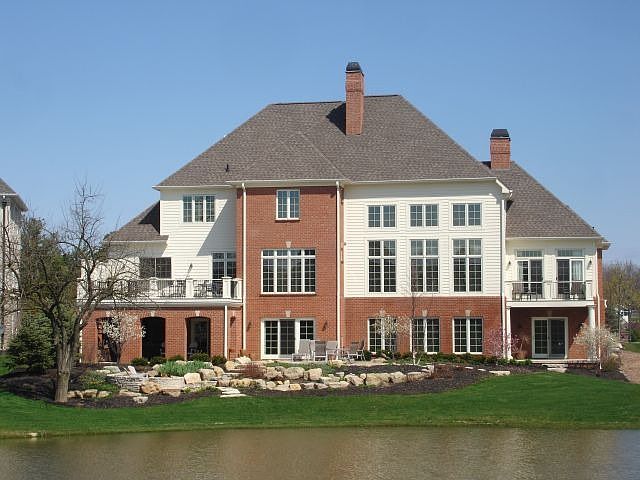 Back of home overlooking pond and the 4th green of Tartan Fields golf course.