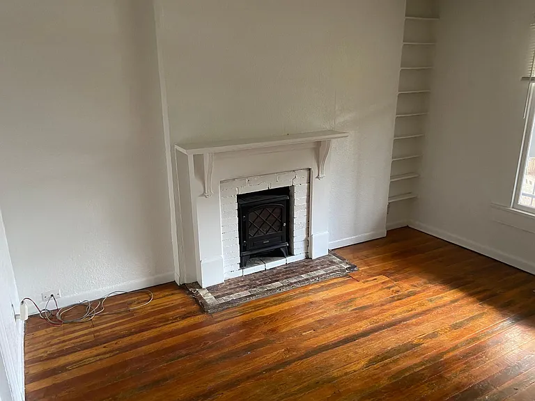 front room on the left when entering. fireplace with stove like space heater with LCD flames