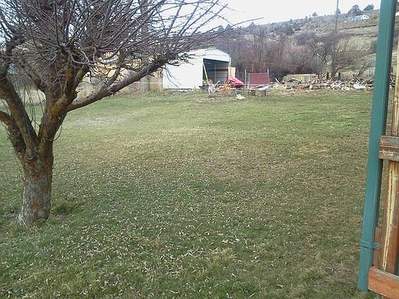 large yard with carport/shed