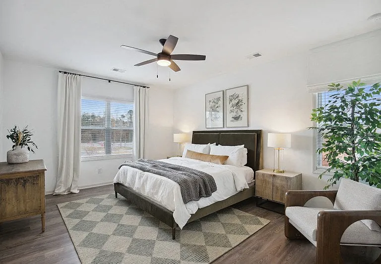 Spacious and calming primary suite with refined decor, a king bed, and nature-inspired accents.