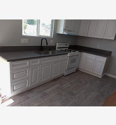 Kitchen with stove, quartz countertops.