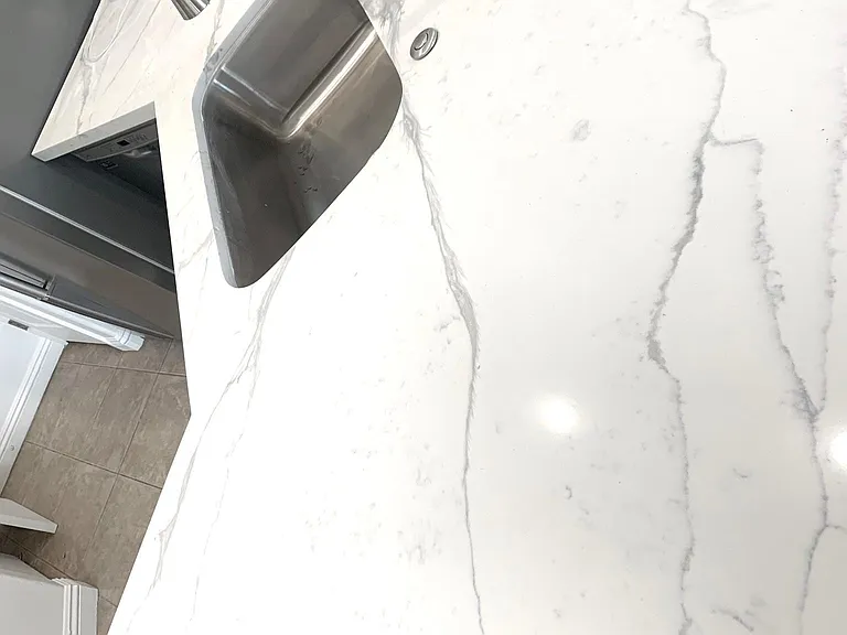 Quartz counter with stainless steel sink and appliances