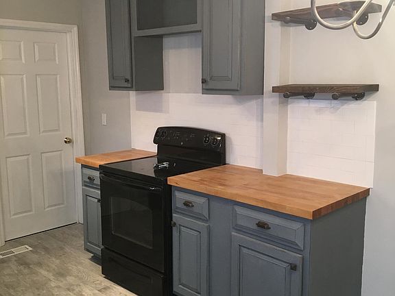 Butcher block countertops and tile backsplash 