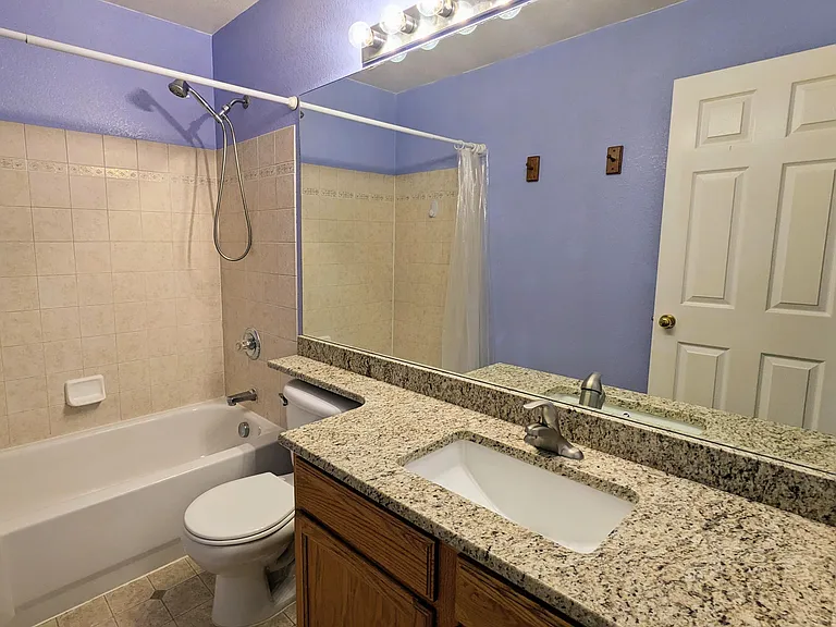 Full upstairs guest bath with granite countertop