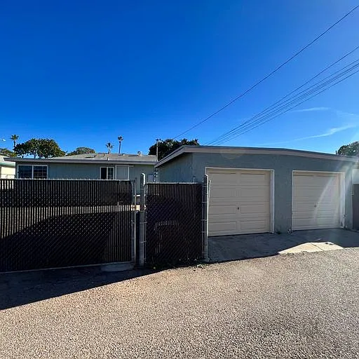 Rear of property. Fenced yard. Alley access and single garage