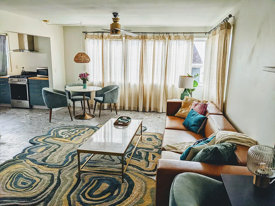 View from entry... Living room, dining area. Comfy leather sofa and new dining table & chairs.