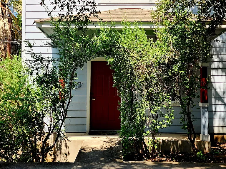 Front door with arched purple sage