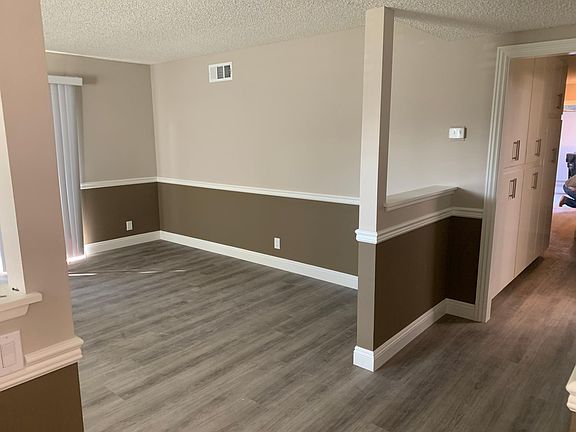 View of living area on the LEFT. The hallway leads to the bedrooms, laundry and 2-car attached garage.