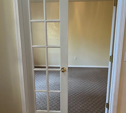 Office with double doors left of front entry.