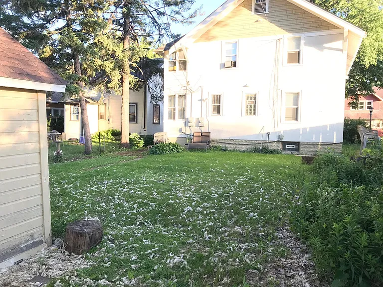 Standing next to garage and facing the house