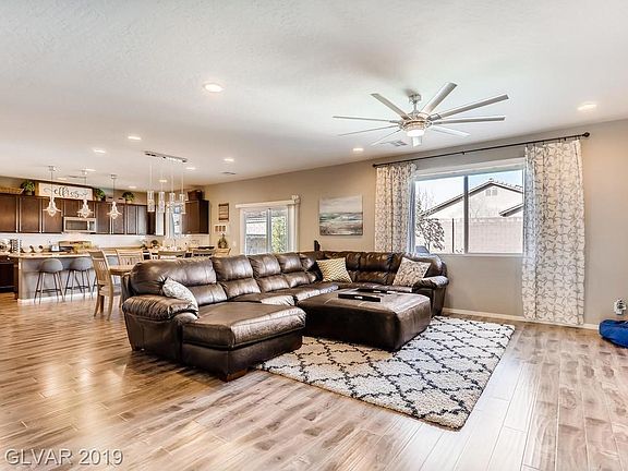Huge family room with wood laminate floors, track lighting, and pure tranquility.