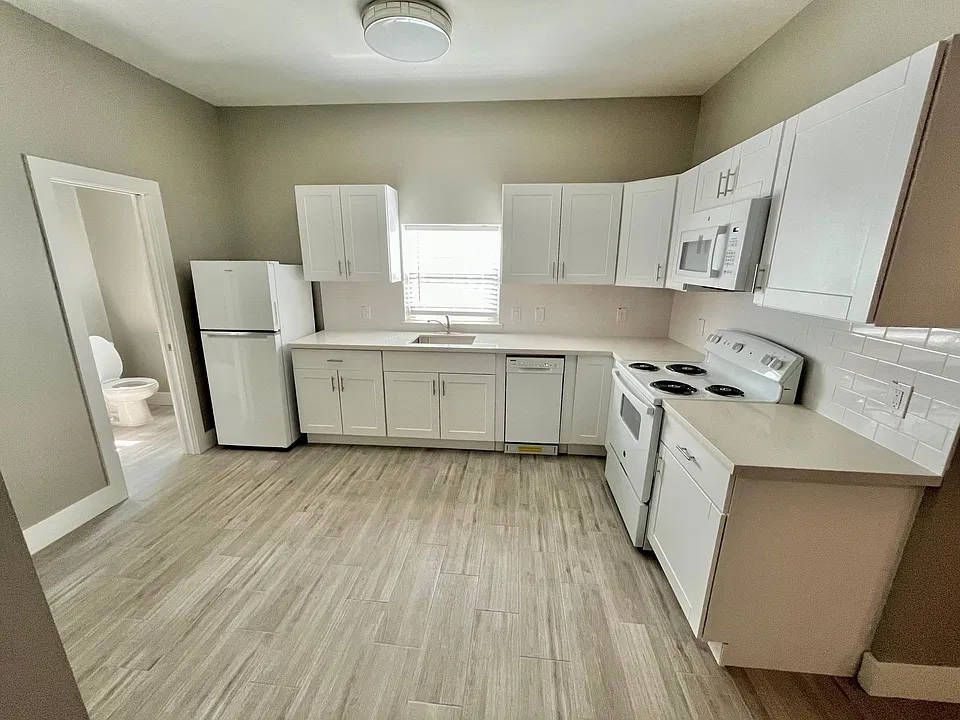Kitchen with all new appliances, great counter space, and lots of storage space. Refrigerator, dishwasher, microwave, and oven/stove. Also room for small dining table.