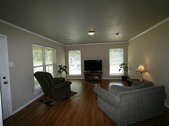 LARGE FAMILY ROOM W/ LAMINATE WOOD FLOOR AND NEW DOUBLE PANE WINDOWS