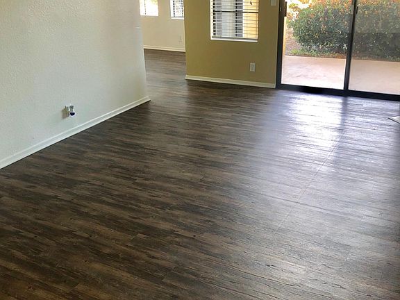 Living Room Leading into Dining Room and Out to Patio
