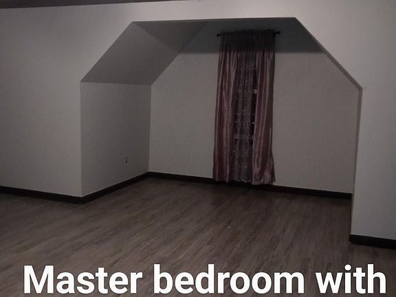 Master bedroom with sitting area and view of the culda sac.