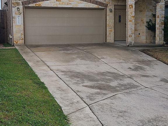 Wide garage entry with lots of outdoor lighting.