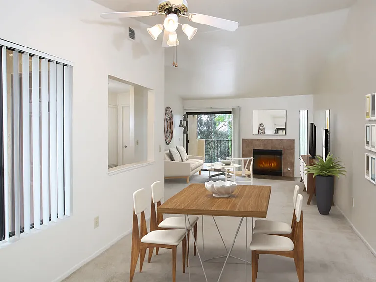 Carpeted Living Room with Fireplace and Balcony