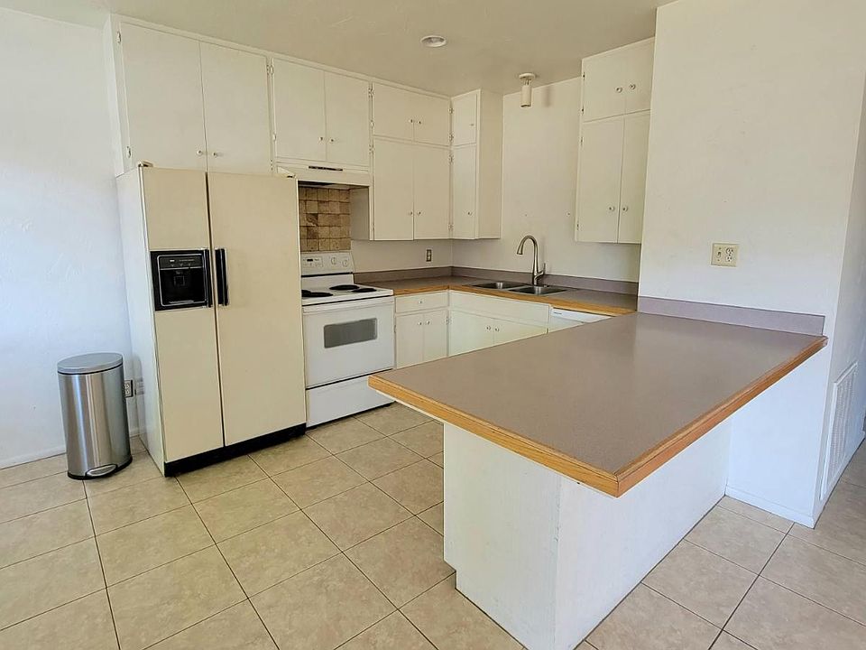 Kitchen area with dishwasher, garbage disposal, refrigerator and stove. Large island counter.