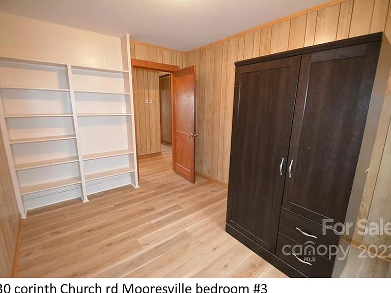 third bedroom with built in shelving (armoire not included