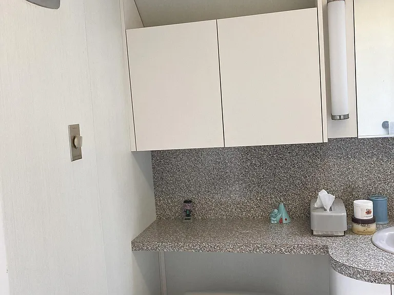 upstairs full bath with sink toilet and bath with shower fan and ceiling window for natural light.