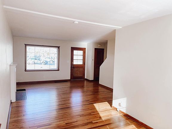 Bright Interior with great natural light. Open floorplan living room and dining room with decorative fireplace.