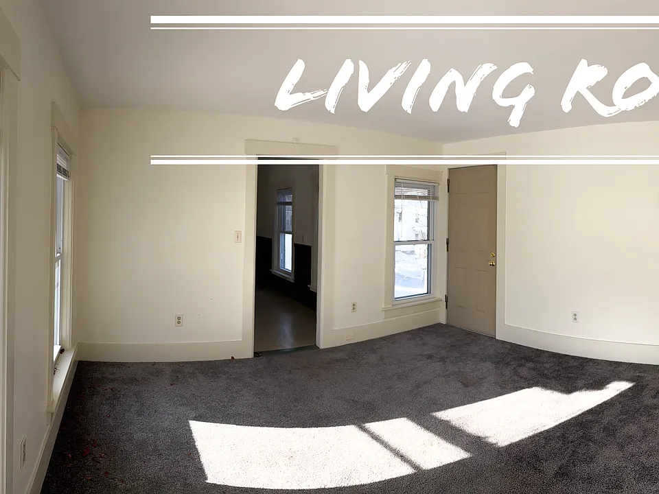 Sunny living room with a sneak peek into the kitchen.