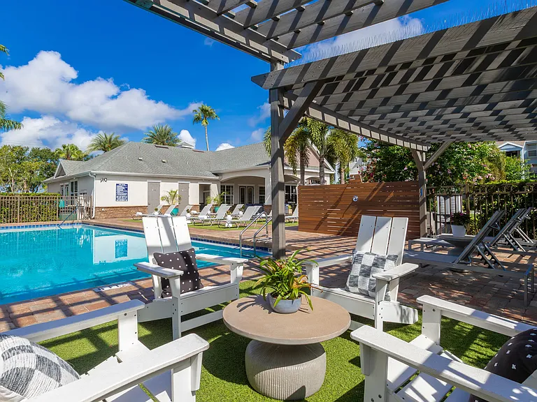 Cool off poolside under our pergola-covered lounge area, perfect for socializing or relaxing in the shade.