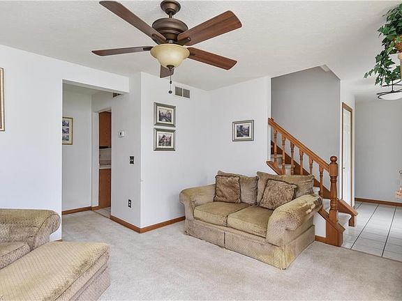 The formal living room measures 12x15 and is fully carpeted.