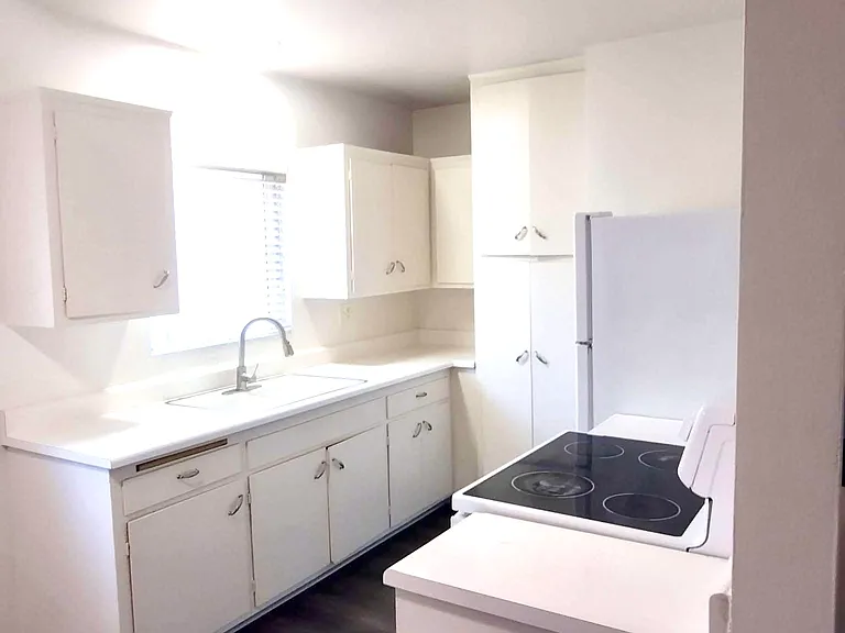 Kitchen facing north west and hall.