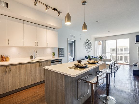 Kitchen islands featuring designer two-tone cabinetry for cooking, dining and entertaining