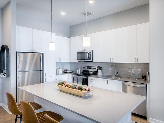Scheme 1 kitchen with quartz countertops, tile backsplash, stainless steel appliances and hard surface flooring