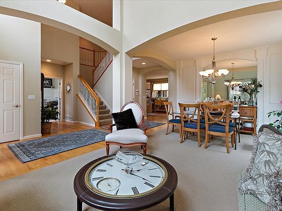 View from Living Room to staircase and Dining Room with architectural archway