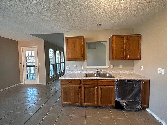 Kitchen sink area as peek through window into living room