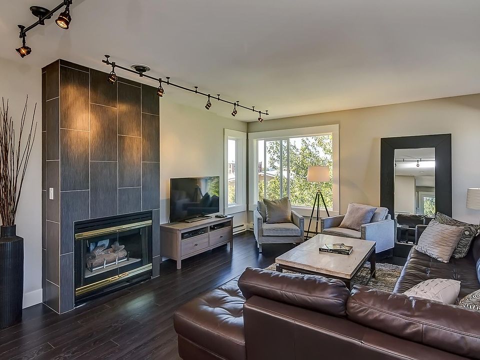 Living room with gas fireplace and laminate flooring