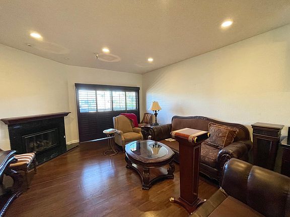 living room w/ gas fireplace & sliding french doors that leads to patio