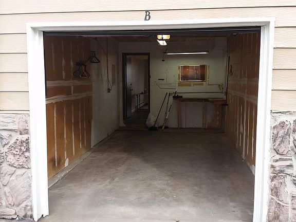 Garage with small work bench and access to the unit