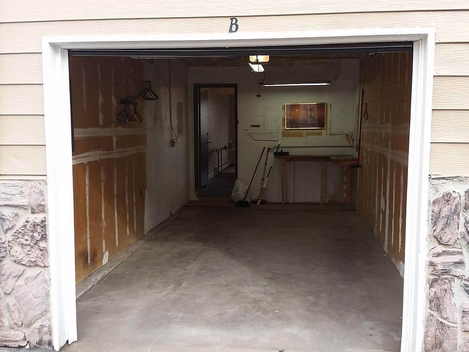 Garage with small work bench and access to the unit