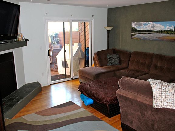 Living room with fireplace opening onto deck