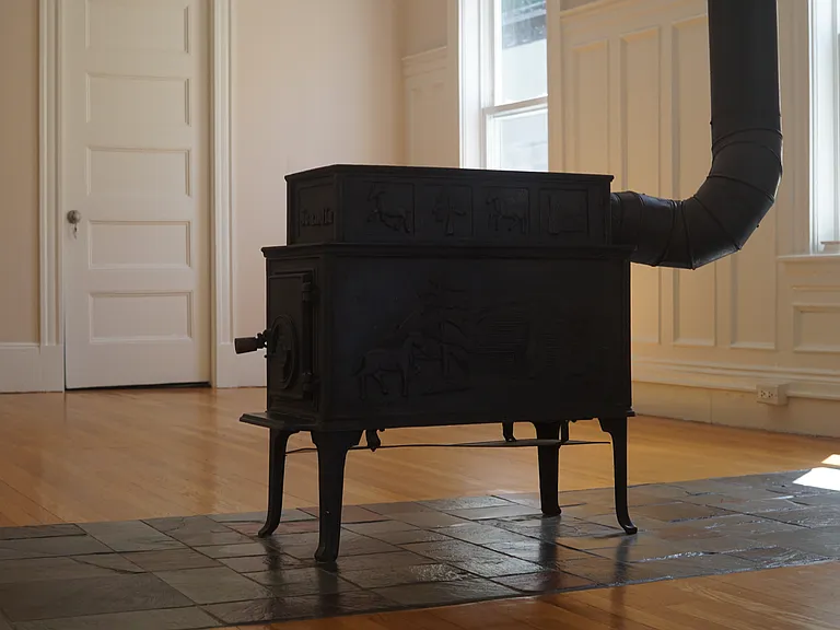 Gorgeous decorative wood fireplace separates living and dinning rooms.