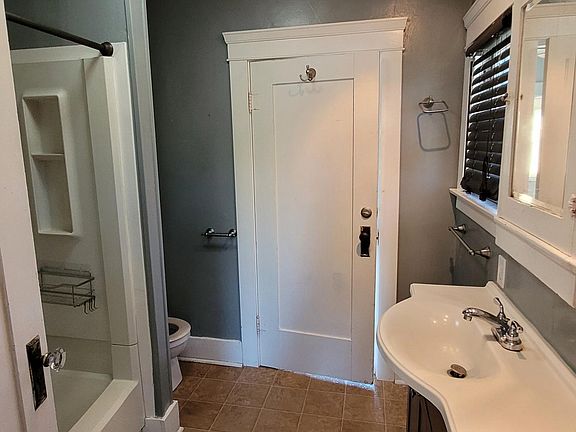 Jack & Jill bathroom with upgraded sink and shower/tub combination. Door to bedroom 2.