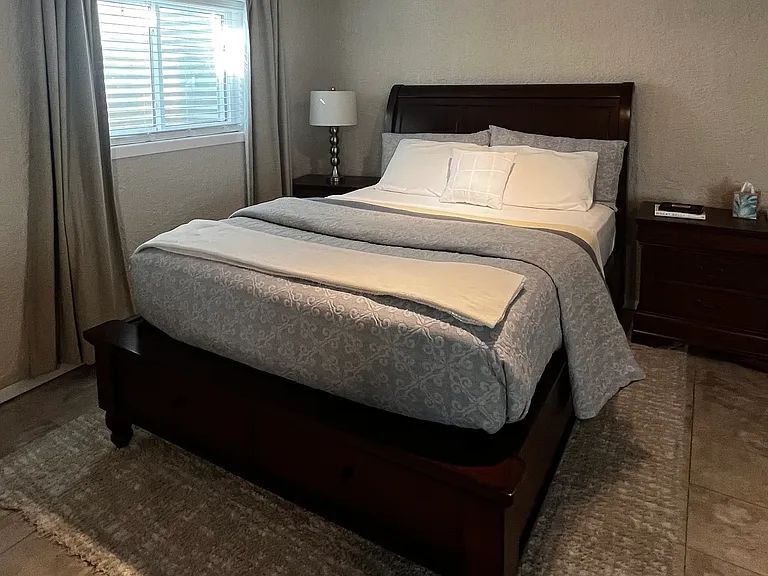Queen-size bed with large under-bed storage drawers.