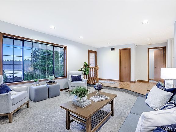 Formal living room with Lake Wilderness views, new carpet and fresh paint.